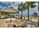Tiki hut with a bar, outdoor seating and waterfront views is ideal for relaxing or entertaining at 1395 S Lake Reedy Blvd, Frostproof, FL 33843