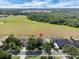 Birds-eye view showcasing the fenced backyard and surrounding greenery, highlighted with a red marker for property location at 2161 Longleaf Cir, Lakeland, FL 33810