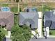 Overhead view of a property featuring a screened pool and fenced yard, bordered by mature trees and adjacent homes at 2161 Longleaf Cir, Lakeland, FL 33810