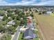 Aerial view of homes, featuring screened pools and spacious yards, near lush greenery at 2161 Longleaf Cir, Lakeland, FL 33810