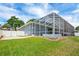 Beautiful backyard with a large screened-in lanai, perfect for outdoor living and entertaining at 2161 Longleaf Cir, Lakeland, FL 33810