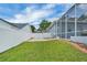 Well-maintained backyard featuring a privacy fence, mature landscaping, and a spacious screened-in lanai at 2161 Longleaf Cir, Lakeland, FL 33810