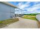 Spacious backyard with a screened-in lanai and view of the lush greenery and serene pool area at 2161 Longleaf Cir, Lakeland, FL 33810