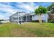 Lush backyard showcasing a screened-in lanai, and a well-manicured lawn, perfect for outdoor enjoyment at 2161 Longleaf Cir, Lakeland, FL 33810
