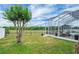 Expansive backyard offering serene views, a screened-in lanai, and lush landscaping for outdoor relaxation at 2161 Longleaf Cir, Lakeland, FL 33810