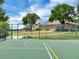 Community basketball court featuring new surfacing, picnic tables, shade trees, and chain link perimeter fence at 2161 Longleaf Cir, Lakeland, FL 33810