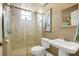 Bright bathroom features a walk-in shower with glass door, light-colored walls, a modern vanity and framed decorative mirror at 2161 Longleaf Cir, Lakeland, FL 33810