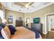 Bedroom with wood floors, tray ceilings, and plenty of storage space from the matching dressers at 2161 Longleaf Cir, Lakeland, FL 33810