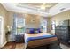 Comfortable bedroom with decorative tray ceilings, hardwood floors and matching dressers at 2161 Longleaf Cir, Lakeland, FL 33810