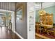Hallway featuring decorative wallpaper and a view into the dining room with a chandelier and built-in china cabinet at 2161 Longleaf Cir, Lakeland, FL 33810