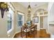 Cozy dining area with a window view, chandelier, and an adjacent kitchen at 2161 Longleaf Cir, Lakeland, FL 33810