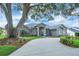 Attractive one-story home with well-kept landscaping, mature trees, and circular driveway for easy access and curb appeal at 2161 Longleaf Cir, Lakeland, FL 33810