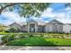Inviting single-story home featuring a well-manicured lawn, lovely shrubs, and mature trees enhancing its curb appeal at 2161 Longleaf Cir, Lakeland, FL 33810
