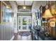 Elegant foyer showcasing decorative wallpaper, hardwood floors, and a view of the front door at 2161 Longleaf Cir, Lakeland, FL 33810