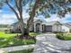 Well-manicured lawn and mature trees frame this home, enhancing its curb appeal and natural setting at 2161 Longleaf Cir, Lakeland, FL 33810