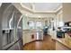 Bright kitchen with stainless steel appliances, wooden floors, and granite countertops at 2161 Longleaf Cir, Lakeland, FL 33810