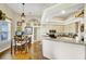 Bright kitchen area with wood floors, white cabinetry, and a breakfast bar, adjacent to dining area at 2161 Longleaf Cir, Lakeland, FL 33810