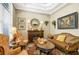 Cozy living room features a fireplace, hardwood floors, neutral paint, and comfortable seating arrangement at 2161 Longleaf Cir, Lakeland, FL 33810