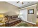 Inviting living room with a leather sofa, patterned rug, hardwood floors, ceiling fan, neutral walls, and a closet at 2161 Longleaf Cir, Lakeland, FL 33810