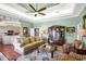 Spacious living room with stylish decor, hardwood floors, and a tray ceiling at 2161 Longleaf Cir, Lakeland, FL 33810