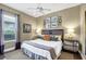 Relaxing main bedroom features natural lighting from the windows and bedside lamps, a ceiling fan, and warm beige walls at 2161 Longleaf Cir, Lakeland, FL 33810
