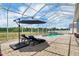 Gorgeous pool area with lounge chairs and an umbrella, perfect for enjoying the Florida sunshine at 2161 Longleaf Cir, Lakeland, FL 33810