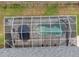 Overhead shot of a screened-in pool and patio area, complete with an umbrella and potted plants for relaxation at 2161 Longleaf Cir, Lakeland, FL 33810