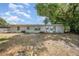 Spacious backyard with a partially fenced in area and mature trees providing plenty of shade at 129 5Th Jpv St, Winter Haven, FL 33880