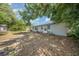 Wide shot of the partially fenced in backyard with a view of the back of the house at 129 5Th Jpv St, Winter Haven, FL 33880