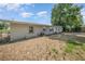 Rear view of the home, highlighting the spacious backyard and mature trees at 129 5Th Jpv St, Winter Haven, FL 33880