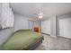 Bedroom featuring a ceiling fan, gray walls, neutral curtains and a closet at 129 5Th Jpv St, Winter Haven, FL 33880