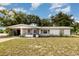 Charming single-story home featuring a screened-in porch and a carport at 129 5Th Jpv St, Winter Haven, FL 33880