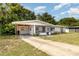 Single-story home with carport and screened-in porch at 129 5Th Jpv St, Winter Haven, FL 33880
