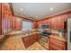 Kitchen featuring granite countertops, stainless steel appliances and wooden cabinetry at 129 5Th Jpv St, Winter Haven, FL 33880