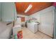 Functional laundry room featuring a washer, dryer, freezer and wood ceiling at 129 5Th Jpv St, Winter Haven, FL 33880