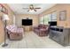 Living room with tile floors, ceiling fan, and large windows providing ample natural light at 129 5Th Jpv St, Winter Haven, FL 33880