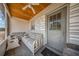 View of Screened porch with ceiling fan, seating and the front door entrance at 129 5Th Jpv St, Winter Haven, FL 33880