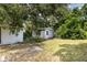 View of the backyard shed in a wooded area at 129 5Th Jpv St, Winter Haven, FL 33880
