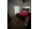 Cozy bedroom featuring a wood-framed bed, natural light from two windows, and a ceiling fan at 1304 Avenue N, Haines City, FL 33844