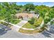 Aerial view of a charming home situated on a corner lot with mature landscaping and a manicured lawn at 1604 Nottingham Dr, Winter Park, FL 32792