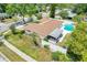 Aerial view of the home featuring a backyard pool, screened patio, and well-maintained landscaping at 1604 Nottingham Dr, Winter Park, FL 32792