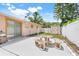Fenced backyard with an outdoor seating area, a storage shed, and a sliding door entry at 1604 Nottingham Dr, Winter Park, FL 32792