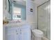 The blue bathroom features a shower, toilet, vanity, mirror, and light blue walls at 1604 Nottingham Dr, Winter Park, FL 32792