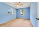 Bedroom featuring blue walls, carpeted floors, and two windows at 1604 Nottingham Dr, Winter Park, FL 32792