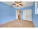 Bedroom featuring blue walls, carpeted floors, a ceiling fan, and a closet at 1604 Nottingham Dr, Winter Park, FL 32792