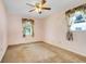 Bedroom with carpeted floor and two windows dressed in floral print curtains at 1604 Nottingham Dr, Winter Park, FL 32792