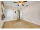 Bedroom with carpeted floor, closet, and a view of the hall at 1604 Nottingham Dr, Winter Park, FL 32792