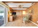 Relaxing bonus room with wood paneling, tile flooring, and sliding door access to the outdoors at 1604 Nottingham Dr, Winter Park, FL 32792