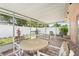 Enclosed patio area with outdoor seating overlooking the landscaped backyard at 1604 Nottingham Dr, Winter Park, FL 32792