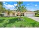 Charming single-story home with manicured lawn, mature trees, and a welcoming two-car garage at 1604 Nottingham Dr, Winter Park, FL 32792